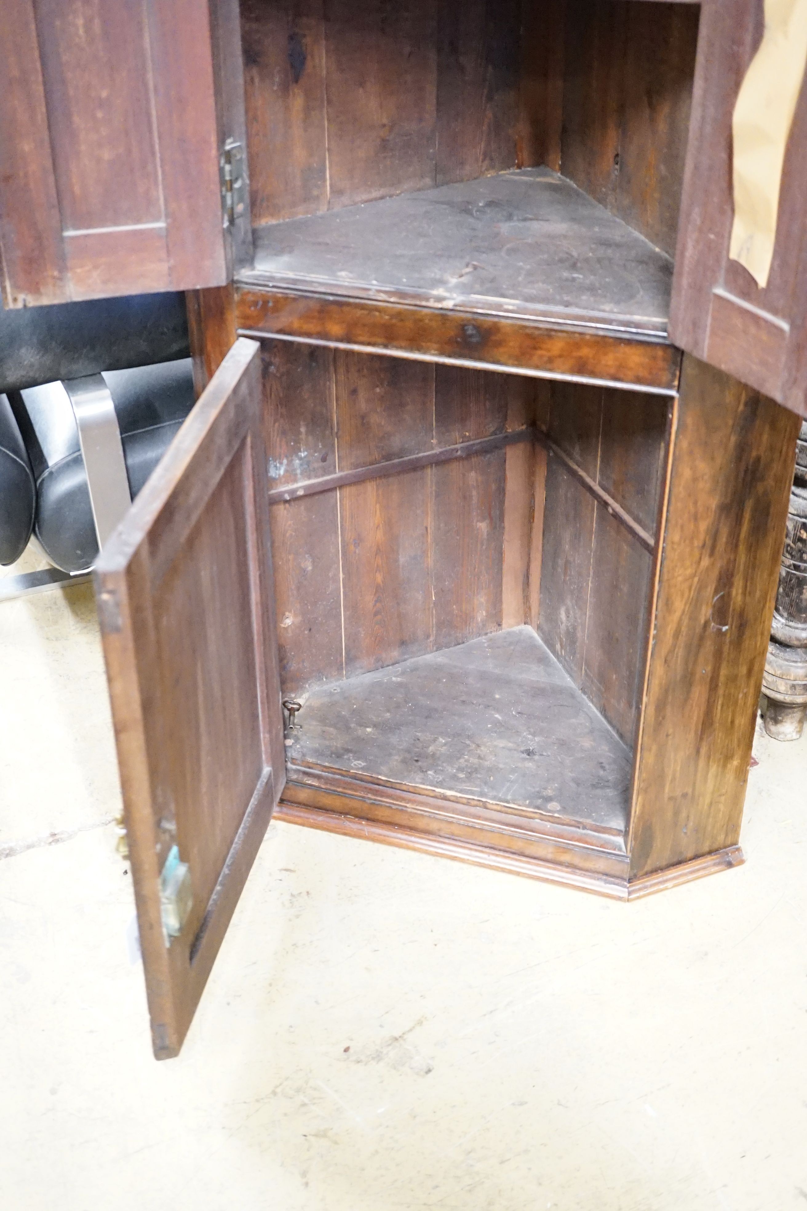 An Edwardian mahogany three door hanging corner cupboard, width 60cm, height 113cm